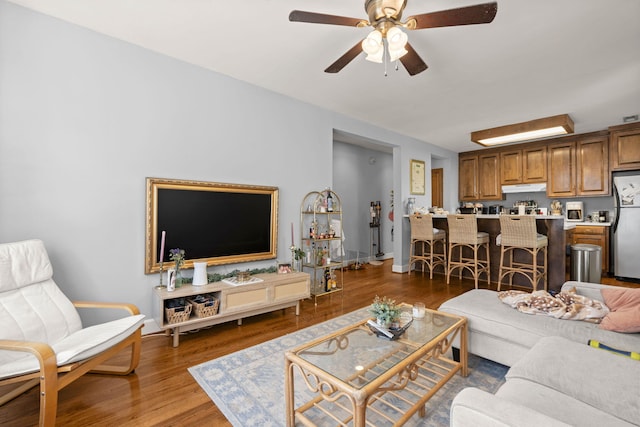 living room with ceiling fan and hardwood / wood-style floors