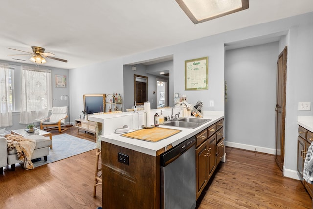 kitchen with sink, ceiling fan, stainless steel dishwasher, and hardwood / wood-style floors