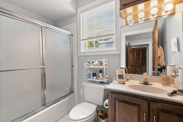 full bathroom featuring bath / shower combo with glass door, vanity, and toilet