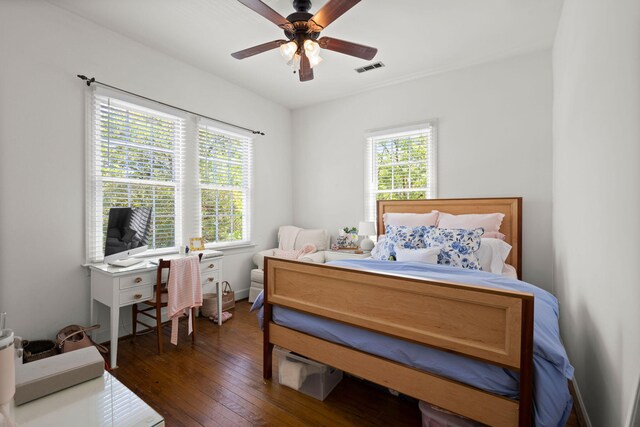 bedroom with dark wood-type flooring, multiple windows, and ceiling fan