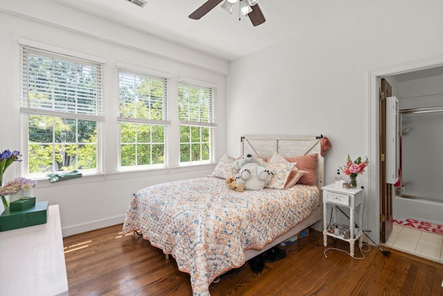 bedroom featuring multiple windows and dark wood-type flooring