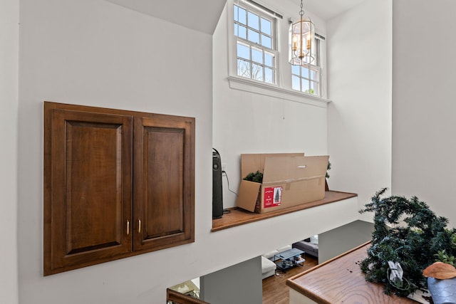 interior details with wood-type flooring and a chandelier