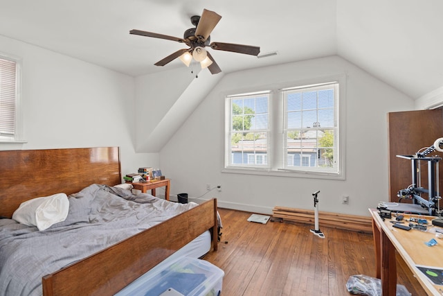 bedroom with ceiling fan, hardwood / wood-style flooring, and lofted ceiling