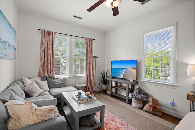 living room featuring a wealth of natural light, ornamental molding, ceiling fan, and hardwood / wood-style floors