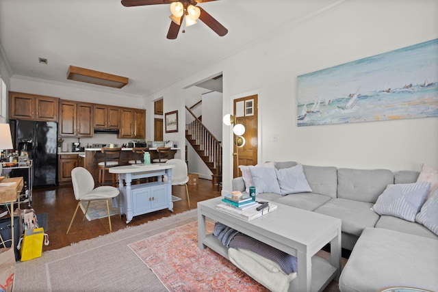 living room featuring ceiling fan, dark hardwood / wood-style floors, and crown molding