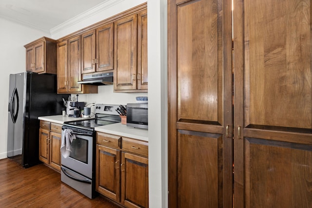 kitchen featuring stainless steel appliances, dark wood-type flooring, and ornamental molding