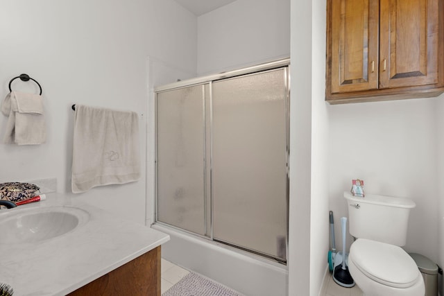 bathroom featuring tile flooring, vanity, and toilet