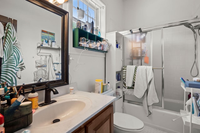 full bathroom with toilet, vanity, and tiled shower / bath