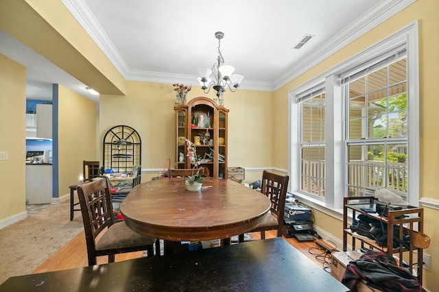 213 Travelers Rest Blvd, Summerville, SC 29485 - dining area featuring a notable chandelier, visible vents, baseboards, and crown molding