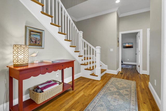 stairway featuring crown molding and wood-type flooring