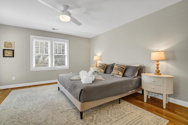 bedroom with ceiling fan and hardwood / wood-style floors