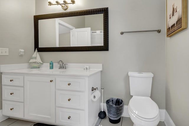 bathroom with vanity, toilet, and tile patterned floors