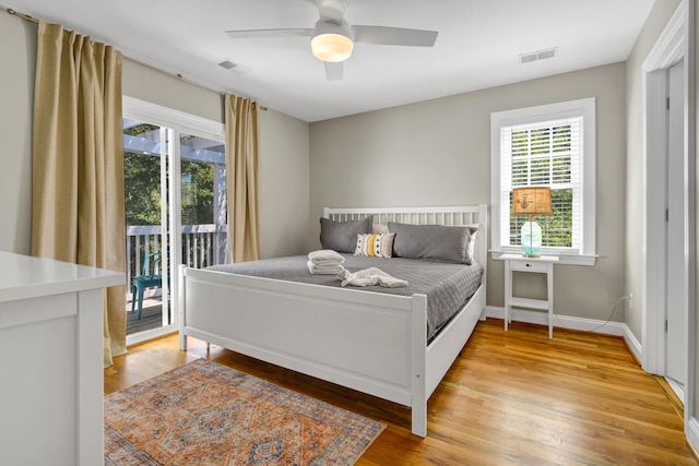 bedroom with multiple windows, access to exterior, light wood-type flooring, and ceiling fan