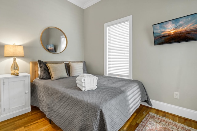 bedroom featuring crown molding and hardwood / wood-style floors