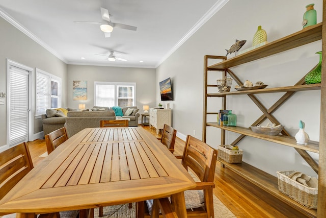 dining room featuring crown molding, hardwood / wood-style flooring, and ceiling fan