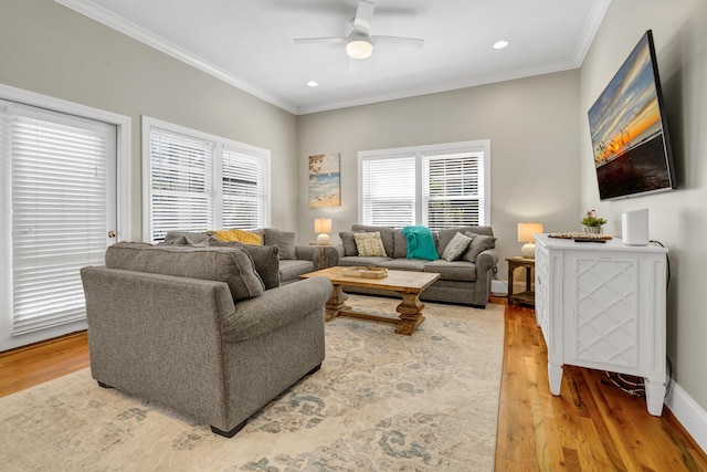 living room with ceiling fan, hardwood / wood-style flooring, and ornamental molding