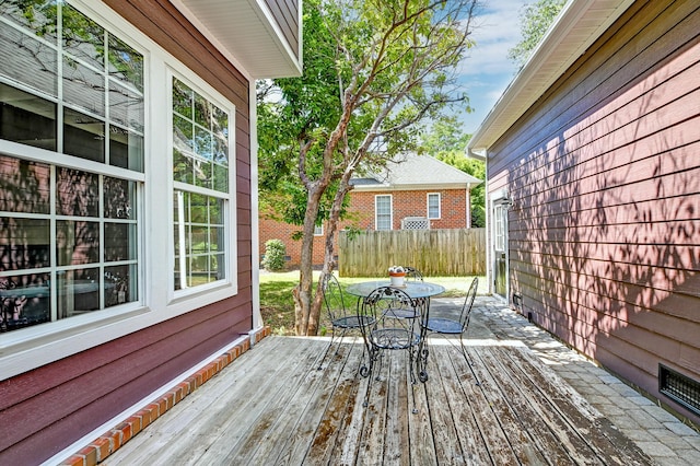 wooden deck featuring outdoor dining space and fence
