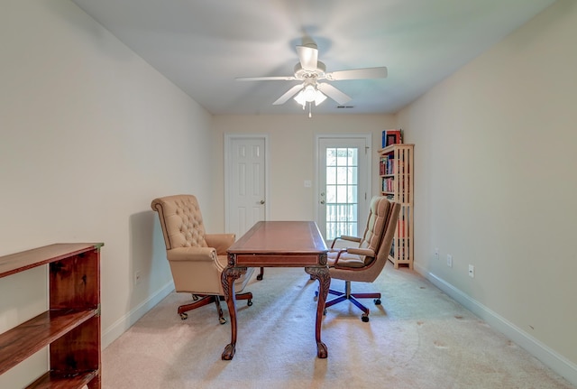 office space with carpet flooring, a ceiling fan, and baseboards