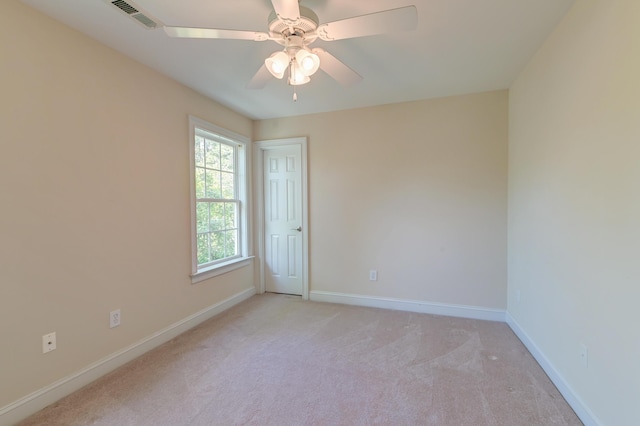 unfurnished room featuring light carpet, baseboards, and a ceiling fan