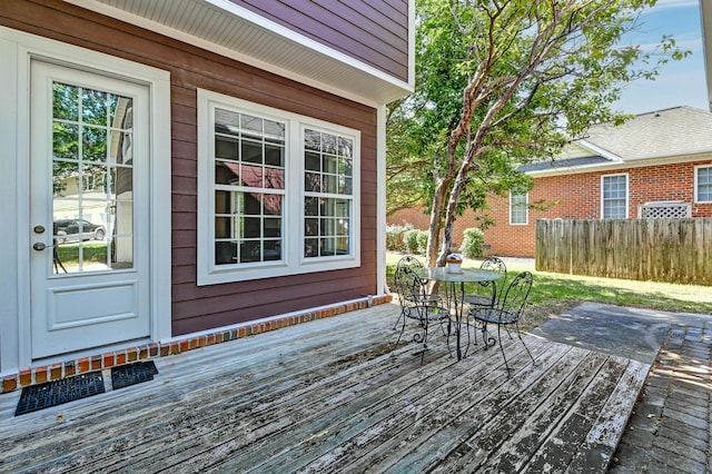 deck featuring outdoor dining space and fence