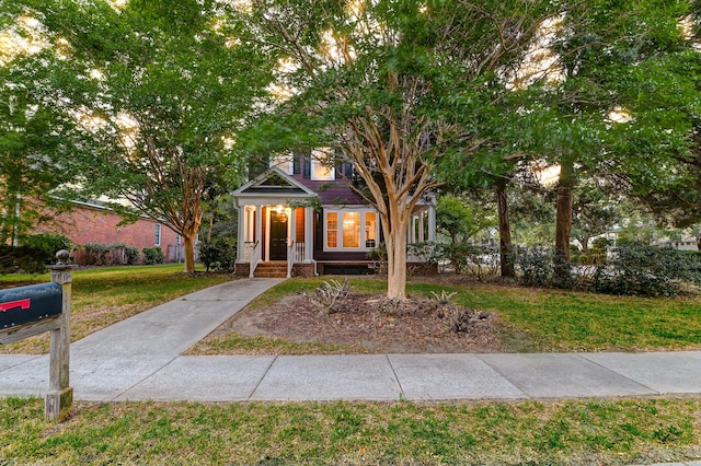 view of property hidden behind natural elements featuring a front lawn