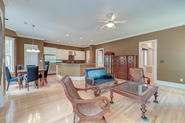 living room with light wood-style floors, a ceiling fan, a chandelier, recessed lighting, and baseboards