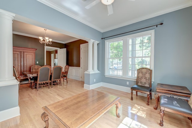 living area featuring decorative columns, light wood finished floors, ornamental molding, ceiling fan, and a chandelier