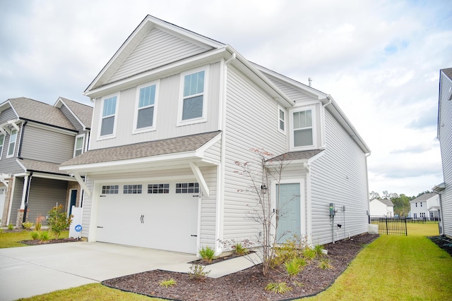 view of front of property with a garage and a front lawn