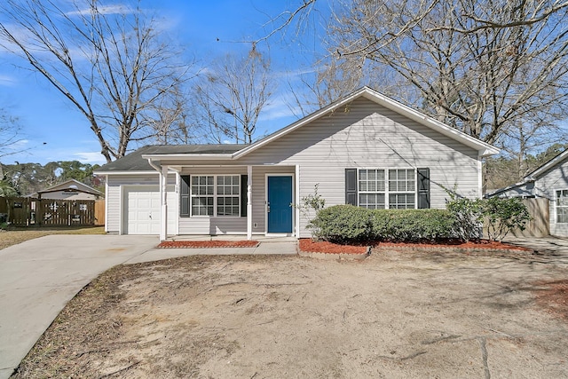 single story home featuring driveway, a garage, and fence