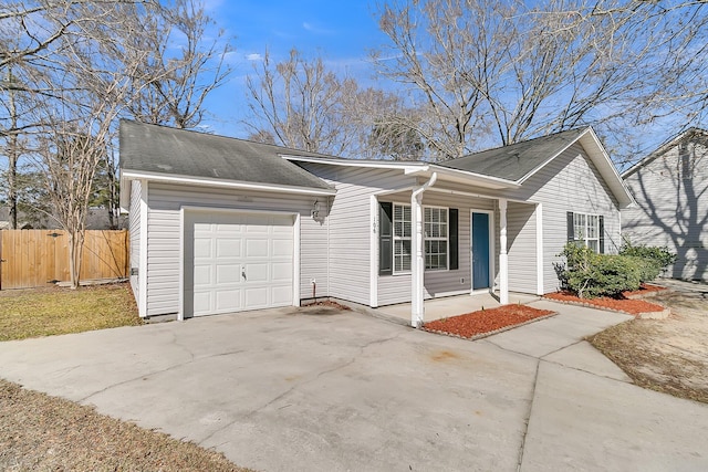 ranch-style house with driveway, a garage, and fence