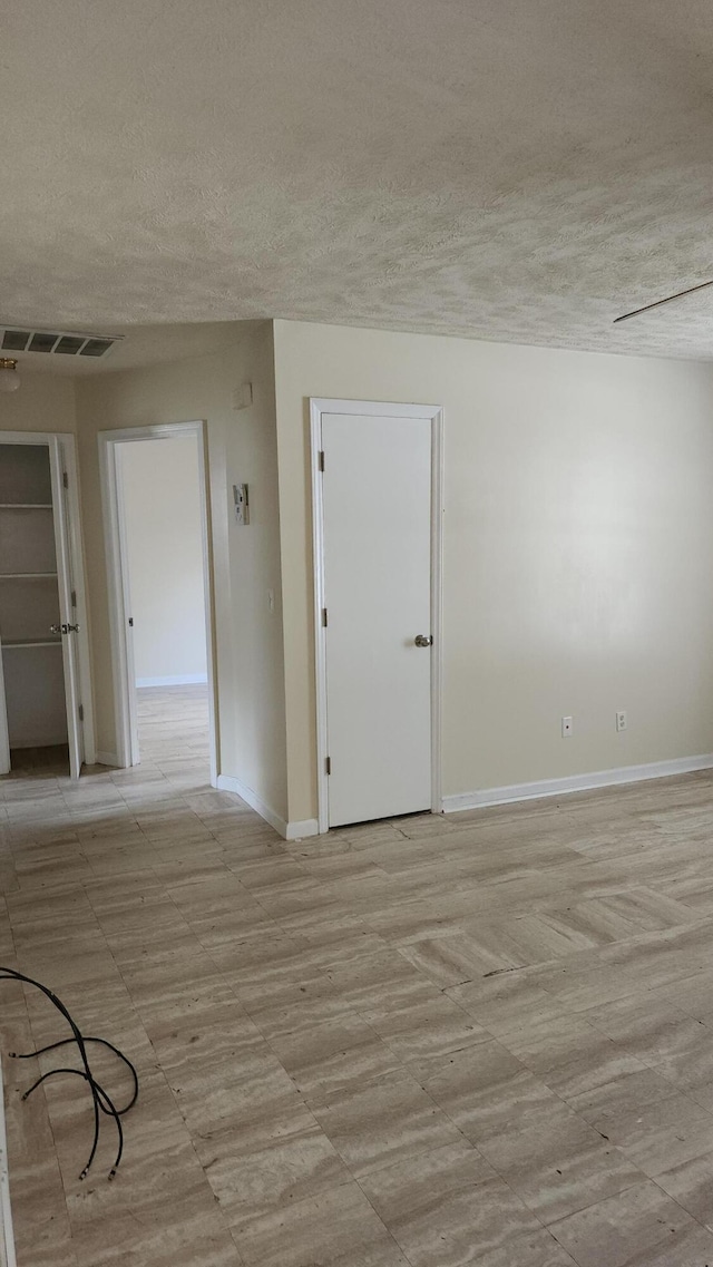 spare room featuring a textured ceiling