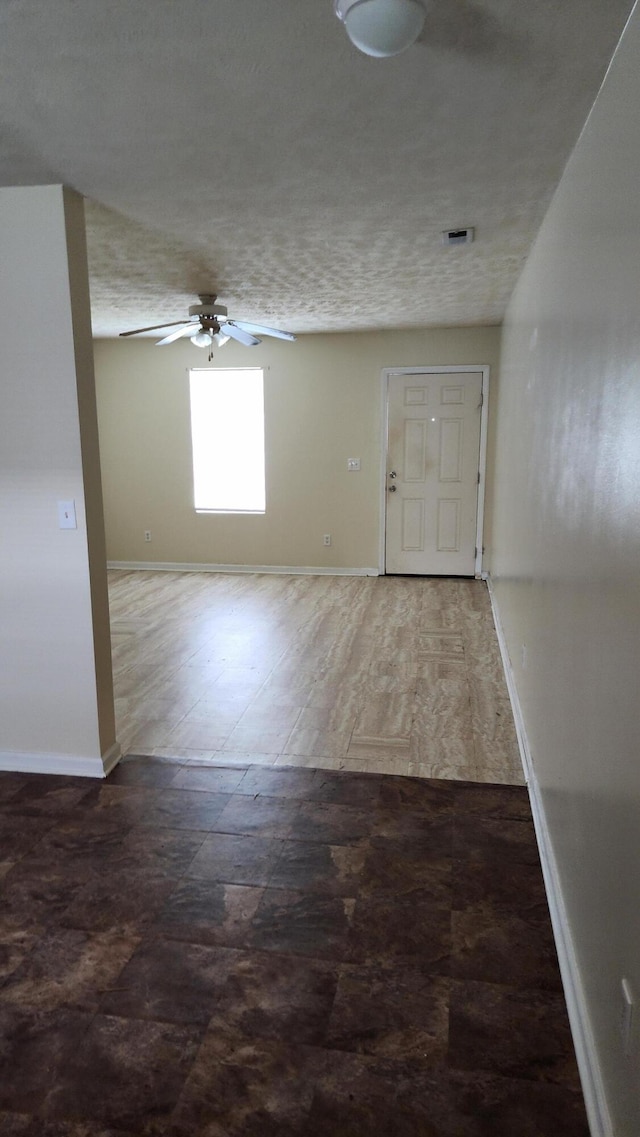 entryway with ceiling fan, hardwood / wood-style floors, and a textured ceiling