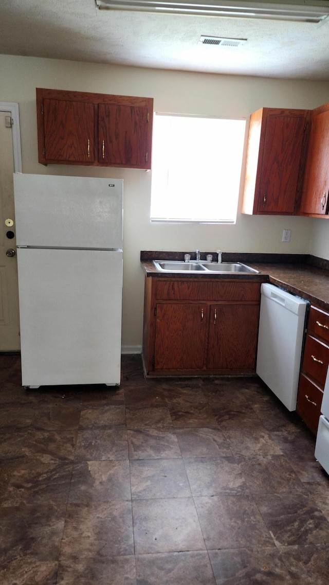 kitchen featuring sink and white appliances