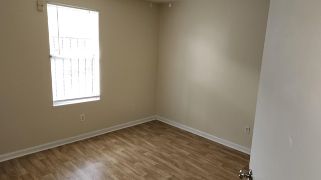 spare room featuring hardwood / wood-style floors