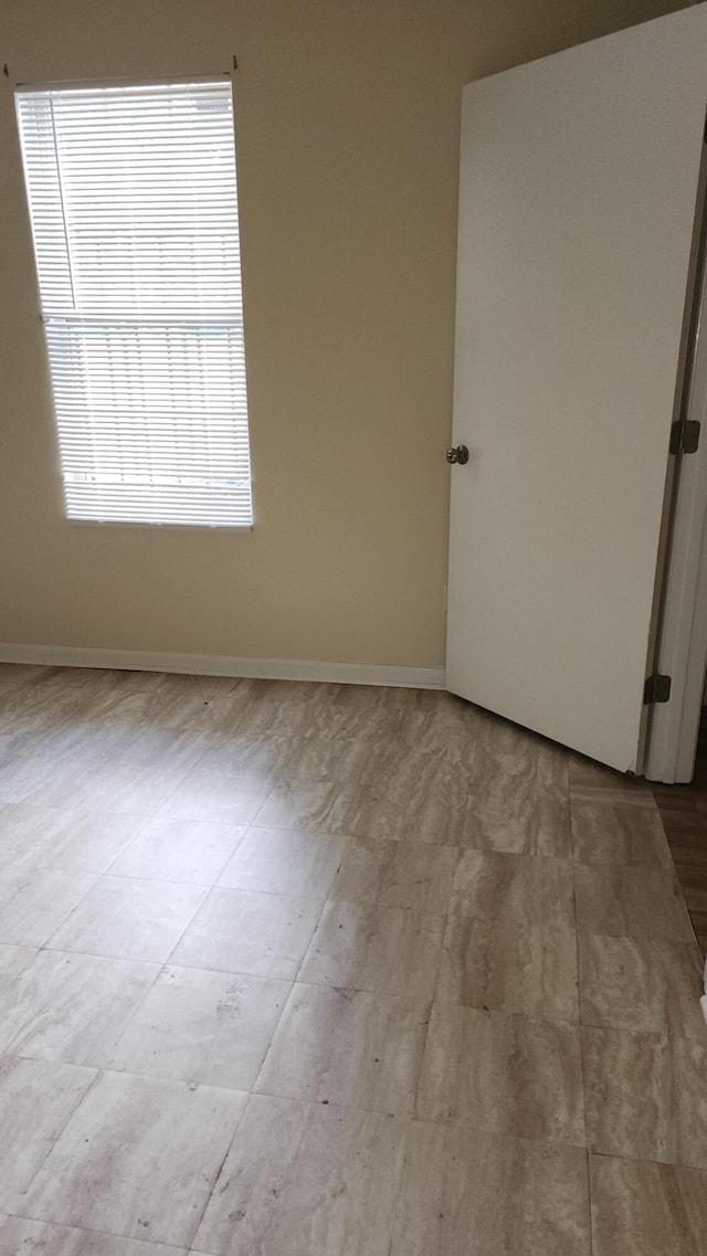 spare room with light wood-type flooring