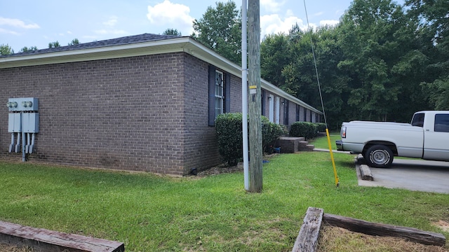 view of side of home featuring a yard