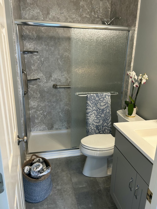 bathroom with vanity, an enclosed shower, and toilet