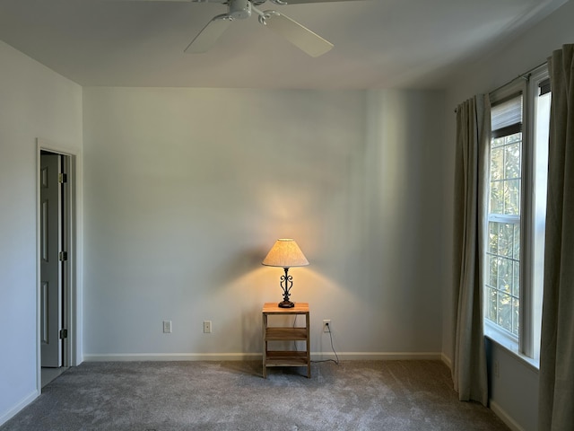 carpeted spare room featuring ceiling fan