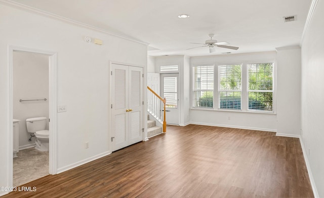 empty room with dark wood-type flooring, ornamental molding, and ceiling fan