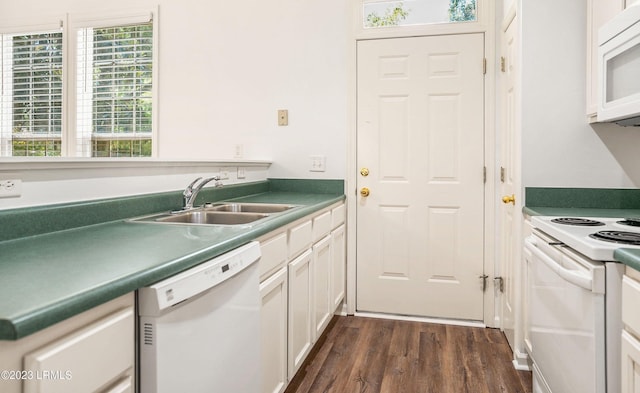 kitchen with white appliances, dark hardwood / wood-style flooring, sink, and white cabinets