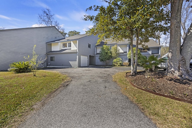 exterior space with aphalt driveway and a garage