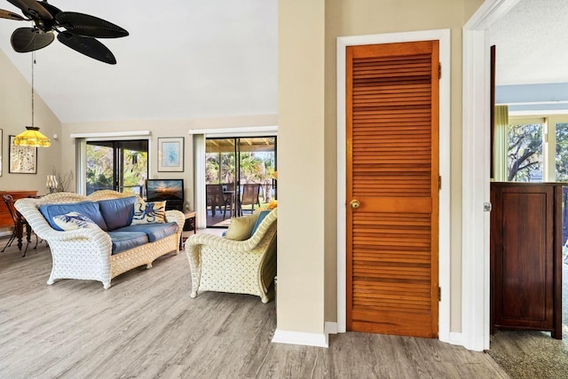 7897 Russell Creek Dr, Edisto Island, SC 29438 - living area featuring wood finished floors, lofted ceiling, ceiling fan, and baseboards