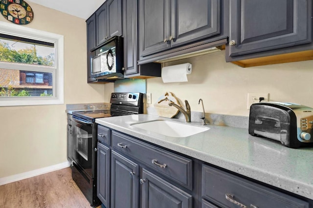 7897 Russell Creek Dr, Edisto Island, SC 29438 - kitchen featuring black appliances, a sink, wood finished floors, and light countertops