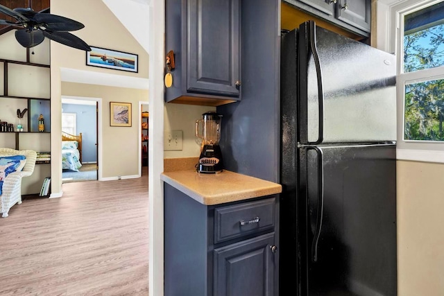 7897 Russell Creek Dr, Edisto Island, SC 29438 - kitchen featuring wood finished floors, a ceiling fan, freestanding refrigerator, baseboards, and light countertops