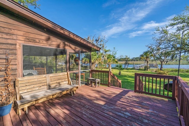 7897 Russell Creek Dr, Edisto Island, SC 29438 - wooden deck featuring a water view, a sunroom, and a yard