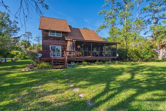 7897 Russell Creek Dr, Edisto Island, SC 29438 - rear view of property with a sunroom, a yard, a shingled roof, and a deck