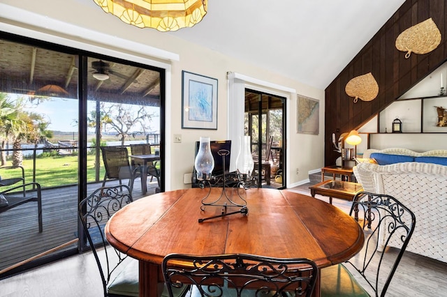 7897 Russell Creek Dr, Edisto Island, SC 29438 - dining room featuring light wood finished floors, lofted ceiling, a ceiling fan, and a water view