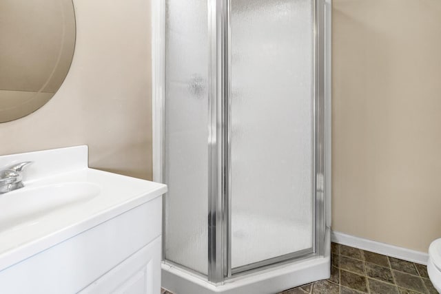 7897 Russell Creek Dr, Edisto Island, SC 29438 - bathroom with a stall shower, vanity, baseboards, and toilet