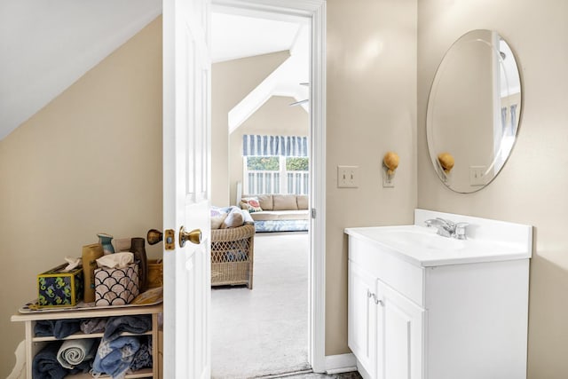 7897 Russell Creek Dr, Edisto Island, SC 29438 - bathroom with vanity, vaulted ceiling, and baseboards