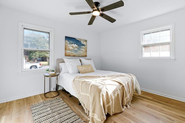 bedroom with ceiling fan and light wood-type flooring